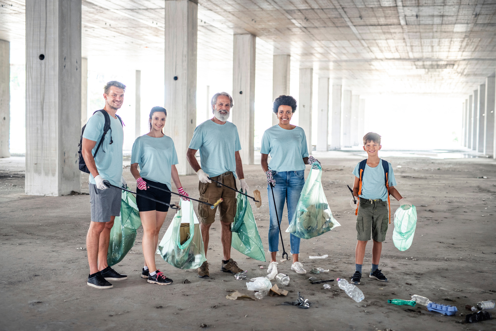 Smiling Community Outreach Team Cleaning Up Outdoor Garage