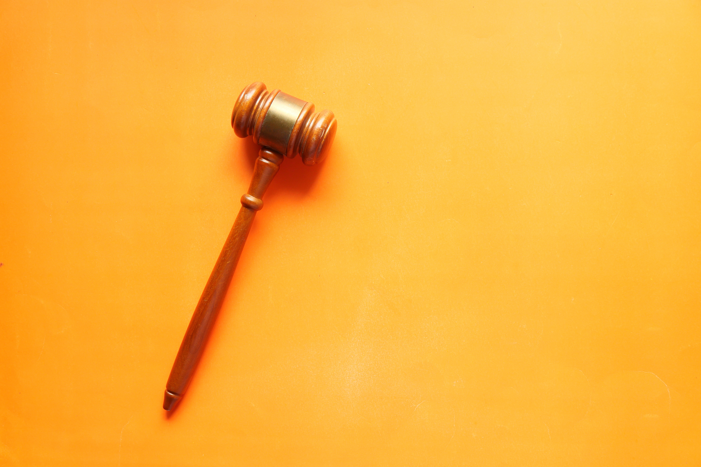 Top View of Gavel on Orange Background